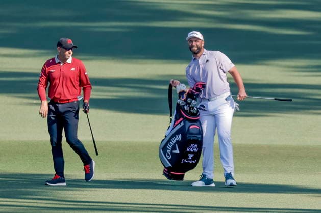 Golf - Masters Tournament round 4 Sergio Garcia (L) reacts after carrying the golf bag for fellow Spaniard Jon Rahm (R) on the fairway of the second hole during the final round of the 2026 Masters Tournament at the Augusta National Golf Club in Augusta, Georgia, USA, 12 April 2026. AUGUSTA GEORGIA United States  Copyright: xERIKxS.xLESSERx