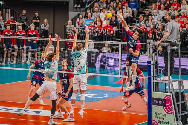 Volleyball Mens Bundesliga playoffs semi-finals 2025 2026 SVG Lüneburg vs SWD powervolleys Düren 12 04 2026 Ethan Champlin 20 SVG Lüneburg against the block of Siebe Korenblek 12 SWD powervolleys Düren and Joris Berkout 3 SWD powervolleys Düren