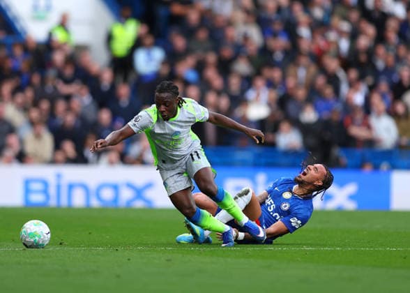 12th April 2026; Stamford Bridge, Chelsea, London, England: Premier League Football, Chelsea versus Manchester City; Malo Gusto of Chelsea tackled by Jeremy Doku of Manchester City JPxFletcher