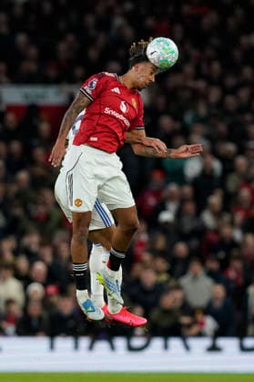 Manchester, England, 13th April 2026. Leny Yoro of Manchester United, ManU and Dominic Calvert-Lewin of Leeds United challenge for the ball during the Manchester United vs Leeds United Premier League match at Old Trafford, Manchester. Picture credit should read: Andrew Yates Sportimage EDITORIAL USE ONLY. No use with unauthorised audio, video, data, fixture lists, club league logos or live services. Online in-match use limited to 120 images, no video emulation. No use in betting, games or single club league player publications. SPI_035_AY_Man_Utd_Leeds SPI-4684-0035