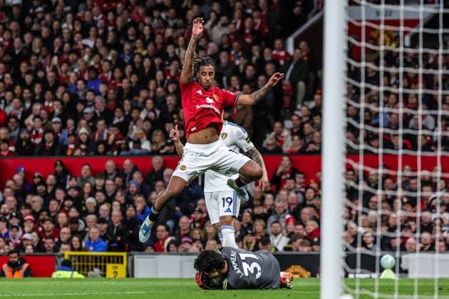 Premier League: Manchester United, ManU v Leeds United Leny Yoro of Manchester United jumps over Manchester United goalkeeper Senne Lammens as he collects the ball during the Premier League match Manchester United vs Leeds United at Old Trafford, Manchester, United Kingdom on 13 April 2026 (Photo by Mark Cosgrove News Images) Manchester Old Trafford Greater Manchester United Kingdom Copyright: xMarkxCosgrove NewsxImagesx