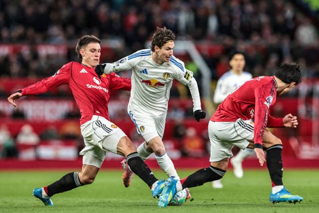Premier League: Manchester United, ManU v Leeds United Brenden Aaronson of Leeds United is tackled by Manuel Ugarte of Manchester United and Lisandro Martinez of Manchester United during the Premier League match Manchester United vs Leeds United at Old Trafford, Manchester, United Kingdom on 13 April 2026 (Photo by Mark Cosgrove News Images) Manchester Old Trafford Greater Manchester United Kingdom Copyright: xMarkxCosgrove NewsxImagesx