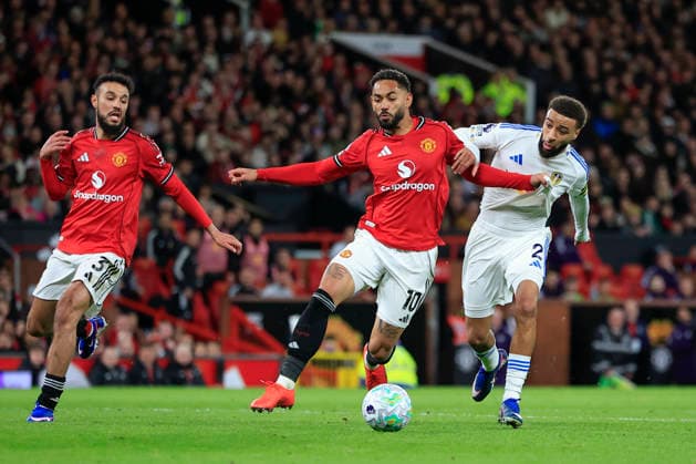 Manchester United, ManU v Leeds United, Premier League Matheus Cunha (10) of Manchester United is challenged by Jayden Bogle (2) of Leeds United during the Premier League match between Manchester United and Leeds United at Old Trafford, Manchester, UK on 13 April 2026. Manchester Old Trafford Greater Manchester UK Editorial use only DataCo restrictions apply See www.football-dataco.com , Copyright: xConorxMolloyx PSI-24063-0121
