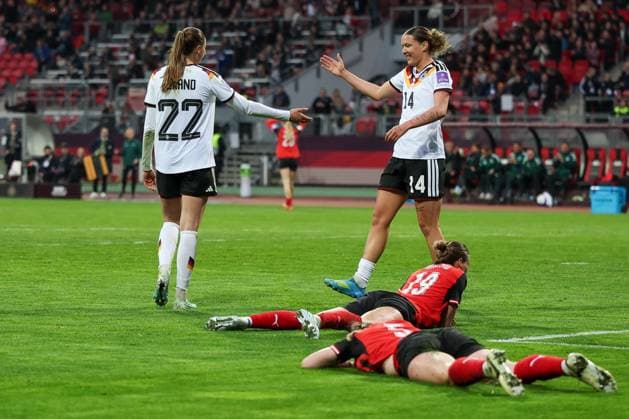 Jule Brand 22 Germany celebrates with Larissa Muehlhaus 14 Germany over her goal to make it 4-0, the Austrian players Verena Hanshaw 19 Austria and Claudia Wengner 5 Austria lie disappointed on the ground, Germany vs. Austria, DFB, Football, Women, Womens World Cup Qualification, Group Stage, Group D, Matchday 3 of 6, Season 2025 26, 14 04 2026 Nuremberg Bayern Germany Copyright: xkolbert-press MartinxAgüerax