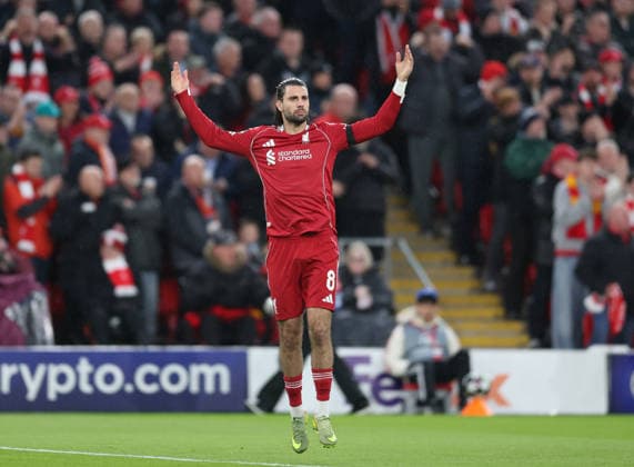 Liverpool, England, 14th April 2026. Dominik Szoboszlai of Liverpool encourages the fans during the Liverpool vs Paris Saint Germain UEFA Champions League quarter final 2nd leg match at Anfield, Liverpool. Picture credit should read: Jessica Hornby Sportimage EDITORIAL USE ONLY. No use with unauthorised audio, video, data, fixture lists, club league logos or live services. Online in-match use limited to 120 images, no video emulation. No use in betting, games or single club league player publications. SPI_050_JH_Liverpool_PSG SPI-4687-0049