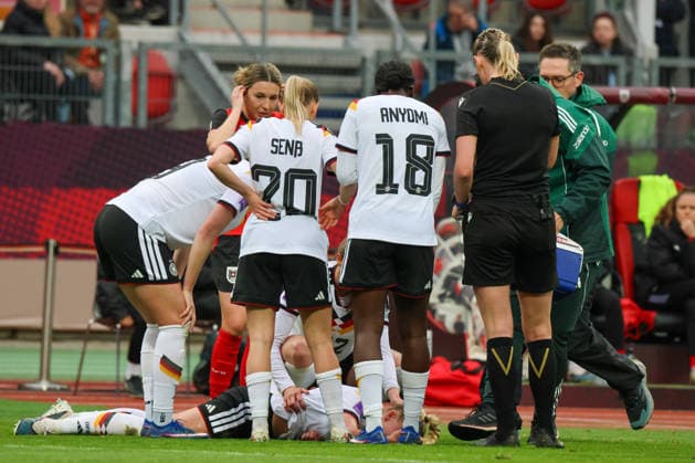 Nuremberg, Germany 14 April 2026 World Cup qualifier Germany vs Austria In the picture Giulia Gwinn Germany injured on the pitch and her teammates look after her Copyright: HMBxMedia MadeleinexFantini