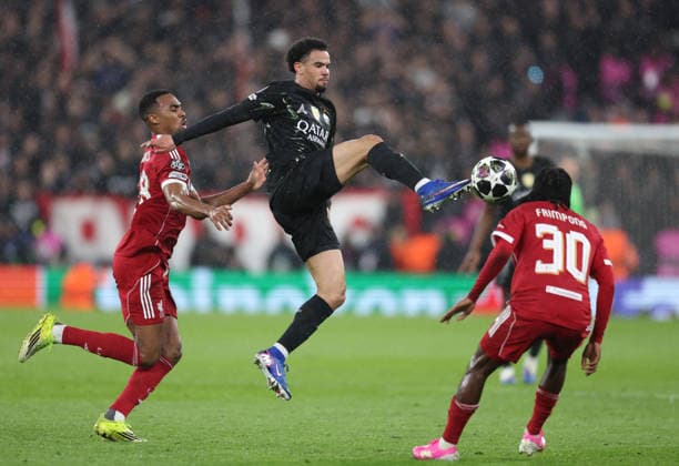 Liverpool, England, 14th April 2026. Warren Zaire-Emery of Paris St Germain leaps up to get to the ball before Ryan Gravenberch of Liverpool (l) during the Liverpool vs Paris Saint Germain UEFA Champions League quarter final 2nd leg match at Anfield, Liverpool. Picture credit should read: Jessica Hornby Sportimage EDITORIAL USE ONLY. No use with unauthorised audio, video, data, fixture lists, club league logos or live services. Online in-match use limited to 120 images, no video emulation. No use in betting, games or single club league player publications. SPI_075_JH_Liverpool_PSG SPI-4687-0075