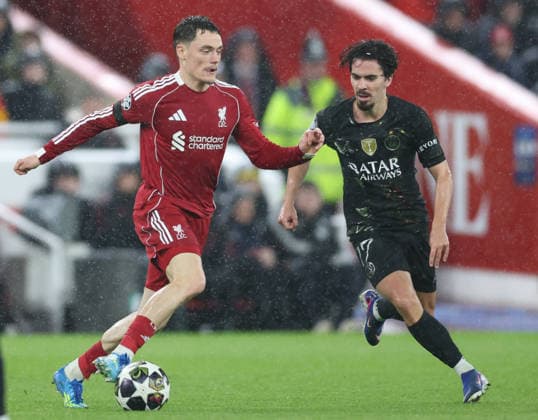 Liverpool, England, 14th April 2026. Florian Wirtz of Liverpool (l) and Vitinha of Paris Saint-Germain (r) during the Liverpool vs Paris Saint Germain UEFA Champions League quarter final 2nd leg match at Anfield, Liverpool. Picture credit should read: Jessica Hornby Sportimage EDITORIAL USE ONLY. No use with unauthorised audio, video, data, fixture lists, club league logos or live services. Online in-match use limited to 120 images, no video emulation. No use in betting, games or single club league player publications. SPI_079_JH_Liverpool_PSG SPI-4687-0079
