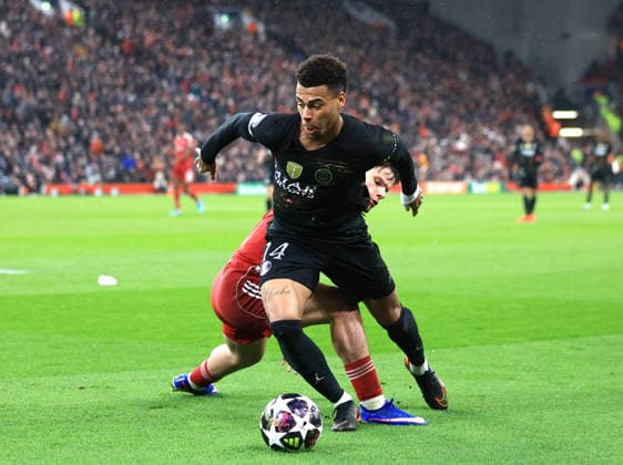 Liverpool, England, 14th April 2026. Milos Kerkez of Liverpool challenges Desire Doue of Paris Saint-Germainduring the Liverpool vs Paris Saint Germain UEFA Champions League quarter final 2nd leg match at Anfield, Liverpool. Picture credit should read: Jessica Hornby Sportimage EDITORIAL USE ONLY. No use with unauthorised audio, video, data, fixture lists, club league logos or live services. Online in-match use limited to 120 images, no video emulation. No use in betting, games or single club league player publications. SPI_081_JH_Liverpool_PSG SPI-4687-0080