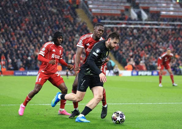 Liverpool, England, 14th April 2026. Khvicha Kvaratskhelia of Paris Saint-Germain gets ahead of Ibrahima Konate of Liverpool during the Liverpool vs Paris Saint Germain UEFA Champions League quarter final 2nd leg match at Anfield, Liverpool. Picture credit should read: Jessica Hornby Sportimage EDITORIAL USE ONLY. No use with unauthorised audio, video, data, fixture lists, club league logos or live services. Online in-match use limited to 120 images, no video emulation. No use in betting, games or single club league player publications. SPI_080_JH_Liverpool_PSG SPI-4687-0082