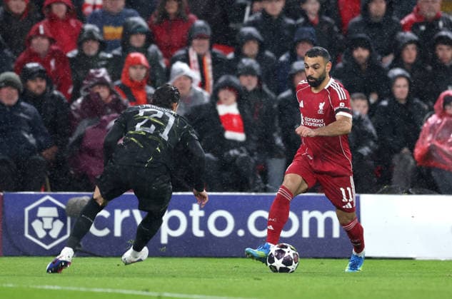 Liverpool, England, 14th April 2026. Lucas Hernandez of Paris St Germain (l) taken on by Mohamed Salah of Liverpool (r) during the Liverpool vs Paris Saint Germain UEFA Champions League quarter final 2nd leg match at Anfield, Liverpool. Picture credit should read: Jessica Hornby Sportimage EDITORIAL USE ONLY. No use with unauthorised audio, video, data, fixture lists, club league logos or live services. Online in-match use limited to 120 images, no video emulation. No use in betting, games or single club league player publications. SPI_088_JH_Liverpool_PSG SPI-4687-0088