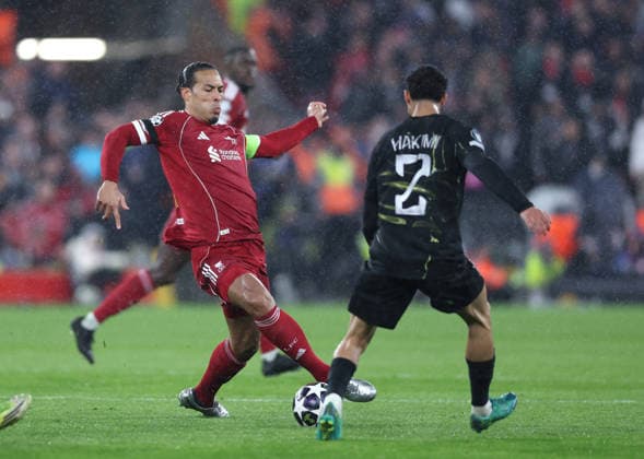 Liverpool, England, 14th April 2026. Virgil van Dijk of Liverpool tussles with Achraf Hakimi of Paris Saint-Germain during the Liverpool vs Paris Saint Germain UEFA Champions League quarter final 2nd leg match at Anfield, Liverpool. Picture credit should read: Jessica Hornby Sportimage EDITORIAL USE ONLY. No use with unauthorised audio, video, data, fixture lists, club league logos or live services. Online in-match use limited to 120 images, no video emulation. No use in betting, games or single club league player publications. SPI_097_JH_Liverpool_PSG SPI-4687-0097