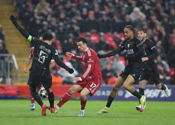 Liverpool, England, 14th April 2026. Curtis Jones of Liverpool tackled by Marquinhos of Paris Saint-Germain during the Liverpool vs Paris Saint Germain UEFA Champions League quarter final 2nd leg match at Anfield, Liverpool. Picture credit should read: Jessica Hornby Sportimage EDITORIAL USE ONLY. No use with unauthorised audio, video, data, fixture lists, club league logos or live services. Online in-match use limited to 120 images, no video emulation. No use in betting, games or single club league player publications. SPI_104_JH_Liverpool_PSG SPI-4687-0104