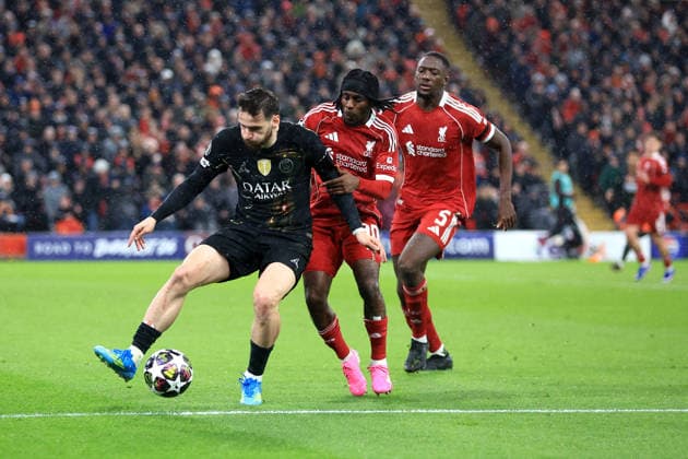 Liverpool, England, 14th April 2026. Khvicha Kvaratskhelia of Paris Saint-Germain is challenged by Jeremie Frimpong of Liverpool during the Liverpool vs Paris Saint Germain UEFA Champions League quarter final 2nd leg match at Anfield, Liverpool. Picture credit should read: Jessica Hornby Sportimage EDITORIAL USE ONLY. No use with unauthorised audio, video, data, fixture lists, club league logos or live services. Online in-match use limited to 120 images, no video emulation. No use in betting, games or single club league player publications. SPI_116_JH_LIVERPOOL_PSG SPI-4687-0116
