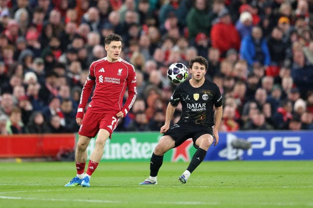 Liverpool, England, 14th April 2026. Florian Wirtz of Liverpool passes the ball whilst under pressure from Joao Neves of Paris Saint-Germain during the Liverpool vs Paris Saint Germain UEFA Champions League quarter final 2nd leg match at Anfield, Liverpool. Picture credit should read: Jessica Hornby Sportimage EDITORIAL USE ONLY. No use with unauthorised audio, video, data, fixture lists, club league logos or live services. Online in-match use limited to 120 images, no video emulation. No use in betting, games or single club league player publications. SPI_125_JH_LIVERPOOL_PSG SPI-4687-0125
