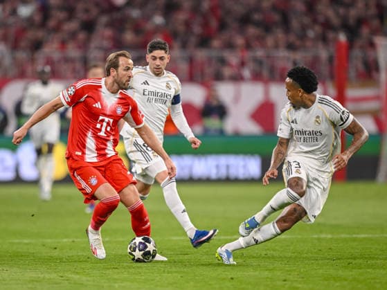 Harry Kane FC Bayern Munich , Federico Valverde Real Madrid and Eder Militae Real Madrid battle for the ball during the UEFA Champions League 2025 26 Quarter Final Second Leg match between FC Bayern Munich and Real Madrid CF at Football Arena Munich on April 15, 2026 in Munich, Germany Photo by Harry Langer DeFodi Images