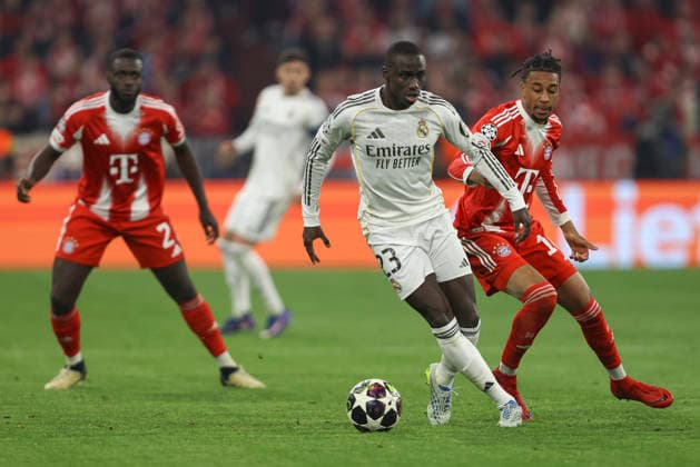 Ferland Mendy Real Madrid C F and Joshua Kimmich FC Bayern München battle for the ball during the UEFA Champions League 2025 26 Quarter Final Second Leg match between FC Bayern München and Real Madrid CF at Football Arena Munich on April 15, 2026 in Munich, Germany Photo by Oliver Kaelke DeFodi Images