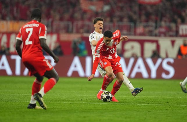 Arda Guler Real Madrid and Jamal Musiala Bayern Munich battle for the ball during Bayern Munich and Real Madrid, UEFA Champions league Quarter Final UEFA Champions League, at Allianz Arena, Munich, Germany on April 15, 2026 Thor Wegner DeFodi Images Photo by DeFodi Images