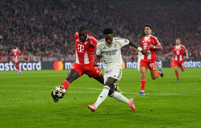 Dayot Upamecano Bayern Munich and Vinicius Junior Real Madrid battle for the ball during Bayern Munich and Real Madrid, UEFA Champions league Quarter Final UEFA Champions League, at Allianz Arena, Munich, Germany on April 15, 2026 Thor Wegner DeFodi Images Photo by DeFodi Images