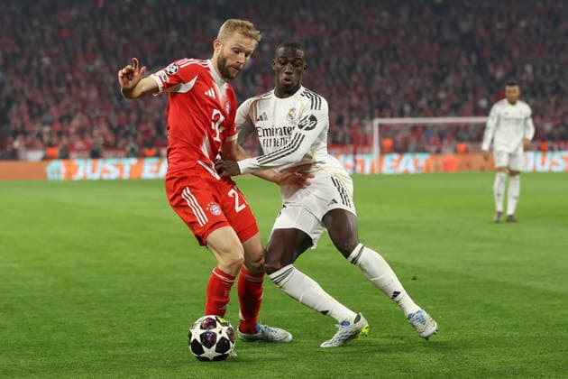 Konrad Laimer FC Bayern München and Ferland Mendy Real Madrid C F battle for the ball during the UEFA Champions League 2025 26 Quarter Final Second Leg match between FC Bayern München and Real Madrid CF at Football Arena Munich on April 15, 2026 in Munich, Germany Photo by Oliver Kaelke DeFodi Images