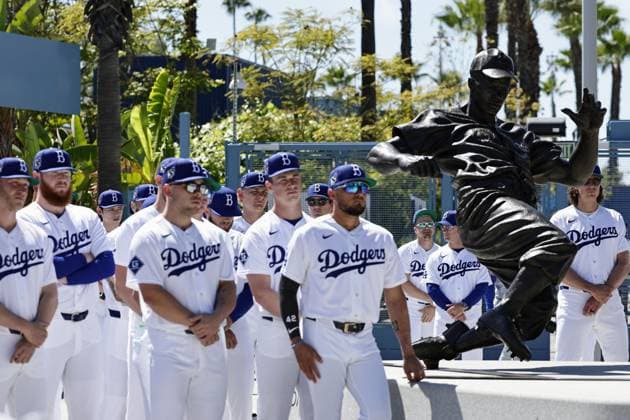Baseball: Jackie Robinson Day Los Angeles Dodgers players attend a ceremony in front of a Jackie Robinson statue outside Dodger Stadium in Los Angeles on April 15, 2026, wearing his No. 42 to pay tribute to the first black major league player prior to a game against the New York Mets. Robinson made his major league debut on April 15, 1947, breaking the baseball color barrier.  A14AA0005462264P