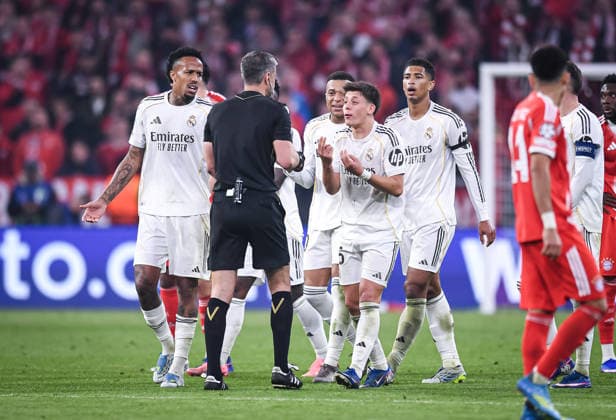 FOOTBALL CHAMPIONS LEAGUE SEASON 2025 2026 Quarter-final second leg 15 04 2026 FC Bayern Munich Real Madrid Referee Slavko Vincic center, Slovenia is pressed by Real Madrid players, Eder Militao, Kylian Mbappe, and Jude Bellingham from left