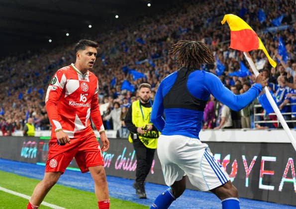 April 16, 2026, Strasbourg, France: Mainz midfielder NADIEM AMIRI (10) shoves Strasbourg forward MARTIAL GODO (20) after placing his jersey atop the corner flag and and waving it at visiting Mainz fans the UEFA Conference League Quarterfinals match between RC Strasbourg and 1. FSV Mainz 05 on April 16, 2026, in Strasbourg, France. Strasbourg won, 4-0, and advances to the semifinals. UEFA Conference League 2026: RC Strasbourg 4:0 Mainz : Quarterfinals  - ZUMAc201 20260416_zap_c201_008 Copyright: xScottxColemanx