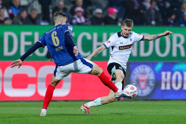 Marko Ivezic Holstein Kiel and Paul Joly 1 FC Kaiserslautern battle for the ball, 2 Bundesliga, Holstein Kiel v 1 FC Kaiserslautern, Holstein Stadion on April 17, 2026 in Kiel, Germany Photo by Marco Steinbrenner DeFodi Images Marko Ivezic Holstein Kiel and Paul Joly 1 FC Kaiserslautern battle for the ball, 2 Bundesliga, Holstein Kiel v 1 FC Kaiserslautern, Holstein Stadion, April 17, 2026 in Kiel, Germany Photo by Marco Steinbrenner DeFodi Images