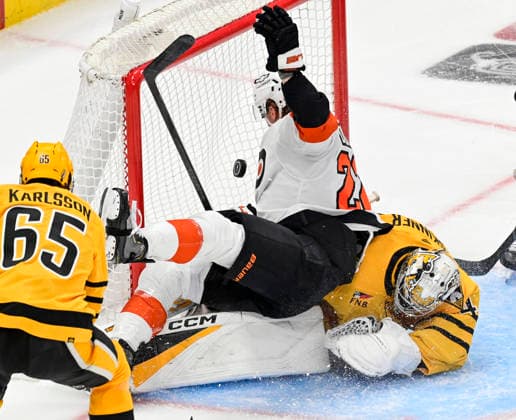 RECORD DATE NOT STATED Philadelphia Flyers center Christian Dvorak (22) collides with Pittsburgh Penguins goaltender Stuart Skinner (74) during the first period of game one in the opening round of the Eastern Conference playoffs at PPG Paints Arena in Pittsburgh on Saturday, April 18, 2026.  PIT2026041802 ARCHIExCARPENTER