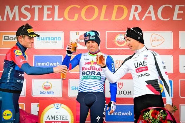 Danish Mattias Skjelmose of Lidl-Trek, Belgian Remco Evenepoel of Red Bull-BORA-hansgrohe and French Benoit Cosnefroy of UAE Team Emirates-XRG celebrate on the podium after the men elite Amstel Gold Race one day cycling race, 257,4 km from Maastricht to Valkenburg, The Netherlands, Sunday 19 April 2026. DIRKxWAEM  x171345664x