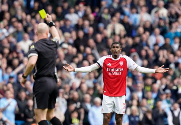 Manchester, England, 19th April 2026. Cristhian Mosquera of Arsenal protest his innocence as he gets a yellow card during the Manchester City vs Arsenal Premier League match at the Etihad Stadium, Manchester. Picture credit should read: Andrew Yates Sportimage EDITORIAL USE ONLY. No use with unauthorised audio, video, data, fixture lists, club league logos or live services. Online in-match use limited to 120 images, no video emulation. No use in betting, games or single club league player publications. SPI_055_AY_Man_City_Arsenal SPI-4704-0054