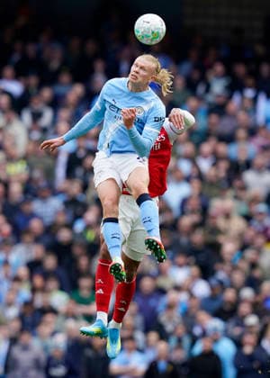 Manchester, England, 19th April 2026. Erling Haaland of Manchester City rises above Gabriel of Arsenal during the Manchester City vs Arsenal Premier League match at the Etihad Stadium, Manchester. Picture credit should read: Andrew Yates Sportimage EDITORIAL USE ONLY. No use with unauthorised audio, video, data, fixture lists, club league logos or live services. Online in-match use limited to 120 images, no video emulation. No use in betting, games or single club league player publications. SPI_061_AY_Man_City_Arsenal SPI-4704-0060