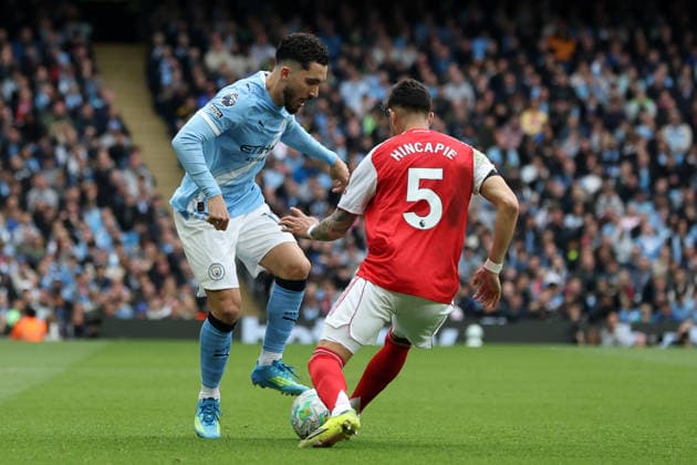 19th April 2026; Etihad Stadium, Manchester, Lancashire, England; Premier League Football, Manchester City versus Arsenal ; Rayan Cherki of Manchester City takes on Piero Hincapie of Arsenal DavidxBlunsden