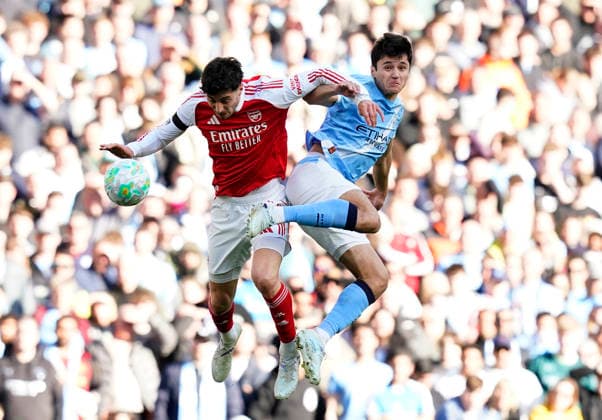 Manchester, England, 19th April 2026. Kai Havertz of Arsenal tussles with Abdukodir Khusanov of Manchester City during the Manchester City vs Arsenal Premier League match at the Etihad Stadium, Manchester. Picture credit should read: Andrew Yates Sportimage EDITORIAL USE ONLY. No use with unauthorised audio, video, data, fixture lists, club league logos or live services. Online in-match use limited to 120 images, no video emulation. No use in betting, games or single club league player publications. SPI_076_AY_Man_City_Arsenal SPI-4704-0075