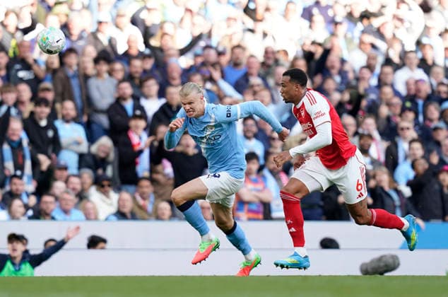 Manchester, England, 19th April 2026. Erling Haaland of Manchester City runs with Gabriel of Arsenal during the Manchester City vs Arsenal Premier League match at the Etihad Stadium, Manchester. Picture credit should read: Andrew Yates Sportimage EDITORIAL USE ONLY. No use with unauthorised audio, video, data, fixture lists, club league logos or live services. Online in-match use limited to 120 images, no video emulation. No use in betting, games or single club league player publications. SPI_095_AY_Man_City_Arsenal SPI-4704-0091