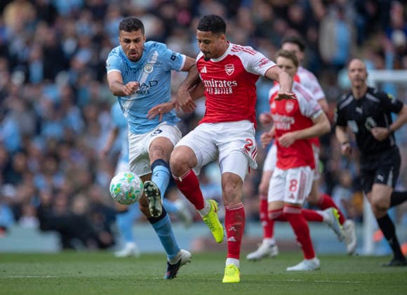Manchester City v Arsenal - Premier League MANCHESTER, ENGLAND - APRIL 19: Rodri of Manchester City and William Saliba of Arsenal in action during the Premier League match between Manchester City and Arsenal at Etihad Stadium on April 19, 2026 in Manchester, England. Rodri; William Saliba Manchester Etihad Stadium England United Kingdom Copyright: xVisionhausx 776340684