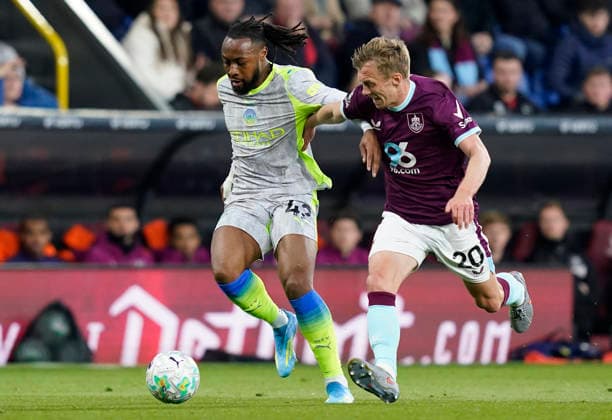 Burnley, England, 22nd April 2026. Antoine Semenyo of Manchester City (L) is challenged by James Ward-Prowse of Burnley during the Burnley vs Manchester City Premier League match at Turf Moor, Burnley. Picture credit should read: Andrew Yates Sportimage EDITORIAL USE ONLY. No use with unauthorised audio, video, data, fixture lists, club league logos or live services. Online in-match use limited to 120 images, no video emulation. No use in betting, games or single club league player publications. SPI_025_AY_BURNLEY_MAN_CITY SPI-4716-0025