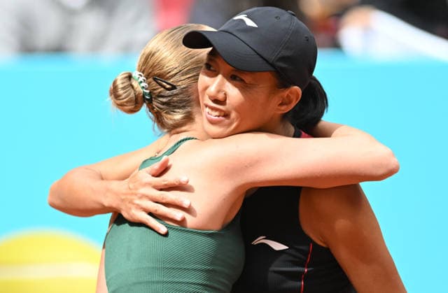 (260424) -- MADRID, April 24, 2026 -- Zhang Shuai (R) hugs Anastasia Potapova after the women s singles round of 64 match between Zhang Shuai of China and Anastasia Potapova of Austria at the 2026 Madrid Open tennis tournament in Madrid, Spain, on April 24, 2026. ) (SP)SPAIN-MADRID-TENNIS-MADRID OPEN-WOMEN S SINGLES ChengxMin 