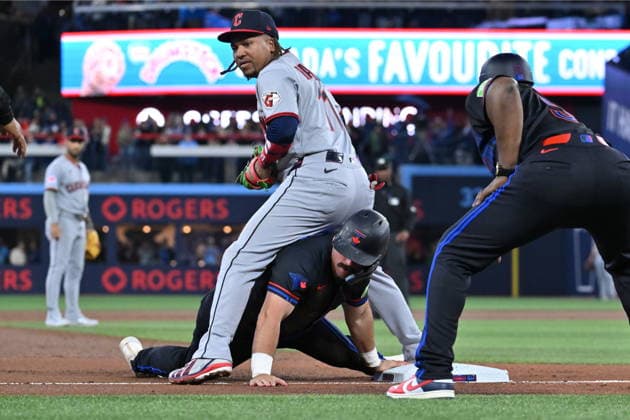 April 24, 2026, Toronto, On, Canada: Toronto Blue Jays Davis Schneider (bottom) slides safely into third base ahead of a tag by Cleveland Guardians third baseman Jose Ramirez (11) in first inning MLB, Baseball Herren, USA baseball game action in Toronto on Friday, April 24, 2026. David Schneider, Jose Ramirez  - ZUMAc35_ 20260424_zaf_c35_098 Copyright: xJonxBlackerx