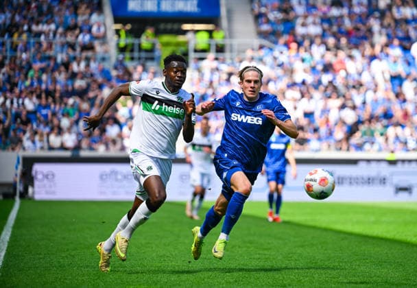 Mustapha Bundu Hannover 96 and David Herold Karlsruher SC battle for the ball during the 2 Bundesliga match between Karlsruher SC and Hannover 96 at BBBank Wildpark on April 25, 2026 in Karlsruhe, Germany Germany Photo by Silas Schüller DeFodi Images Mustapha Bundu Hannover 96 and David Herold Karlsruher SC battle for the ball during the 2 Bundesliga match between Karlsruher SC and Hannover 96 at BBBank Wildpark on April 25, 2026 in Karlsruhe, Germany Photo by Silas Schüller DeFodi Images DFB DFL REGULATIONS PROHIBIT ANY USE OF PHOTOGRAPHS AS IMAGE SEQUENCES AND OR QUASI VIDEO Photo by Silas Schueller DeFodi Images
