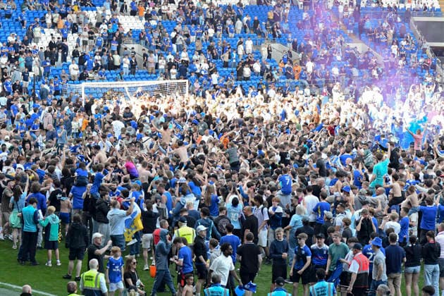 Football - 2025 2026 EFL Sky Bet League One - Cardiff City vs. Northampton Town - Cardiff City Stadium - Saturday 24th April 2026 pITCH INVASION BY CARDIFF FANS HOLDS UP PRESENTATION Pic- COLORSPORT Winston Bynorth 