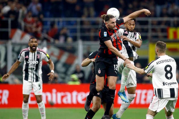 MILAN, ITALY - APRIL 26: Adrien Rabiot of AC Milan heads the ball against Lloyd Kelly of Juventus FC ,during the Serie A match between AC Milan and Juventus FC at Giuseppe Meazza Stadium on April 26, 2026 in Milan, Italy.  Copyright: xMBxMediax