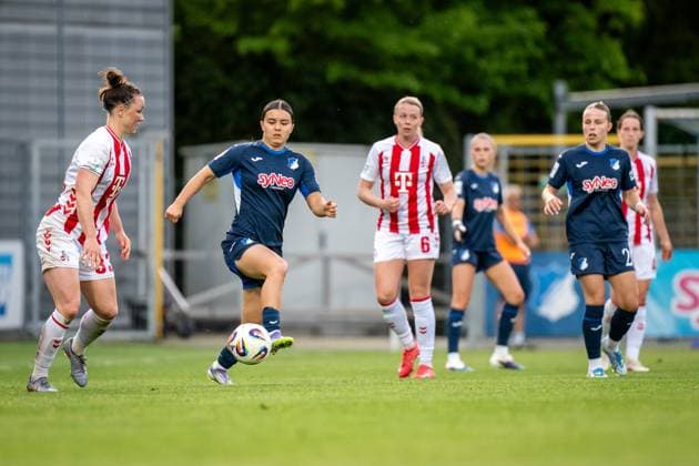 Marina Hegering 33 1 FC Köln with ball while Laura Gloning 20 TSG Hoffenheim and Naomi Luyet 7 TSG Hoffenheim defend at Dietmar Hopp Stadium GPFBL TSG Hoffenheim 1 FC Köln, 27 04 2026 Copyright: xSpeedshotx