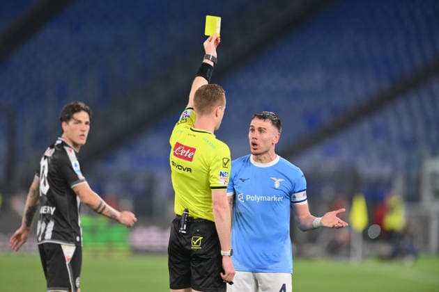 27th April 2026, Stadio Olimpico, Rome, Italy; Italian Serie A Football; Lazio versus Udinese; referee Kevin Bonacina issues a yellow card to Patric of SS Lazio AllShotLive