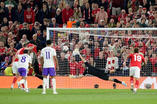 Nottingham, England, 30th April 2026. Chris Wood of Nottingham Forest (l) scores the first goal past Emiliano Martinez of Aston Villa from the penalty spot during the Nottingham Forest vs Aston Villa UEFA Europa League Semi Final 1st leg match at the City Ground, Nottingham. Picture credit should read: Andrew Yates Sportimage EDITORIAL USE ONLY. No use with unauthorised audio, video, data, fixture lists, club league logos or live services. Online in-match use limited to 120 images, no video emulation. No use in betting, games or single club league player publications. SPI_051_AY_Forest_Villa SPI-4767-0051