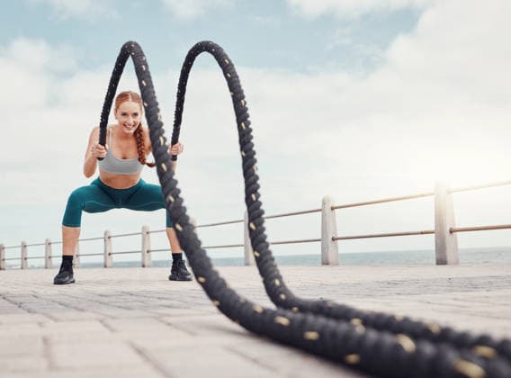 Fitness, woman and battle rope at the beach for intense arm workout, training or exercise in Cape Town. Active female exercising with ropes for cardio, muscle endurance or power in the outdoors. (License=RF) 19817469 ,model released, Symbolfoto  Copyright: xZoonar.com YurixArcursxpeopleimages.comx 19817469 ,model released, Symbolfoto ,property released