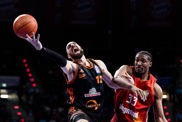 MUNICH, GERMANY - MAY 03: Tommy Kuhse (Rasta Vechta, 12) controls the ball against David McCormack (FC Bayern Muenchen, 33) during the easyCredit Basketball Bundesliga match between FC Bayern Muenchen vs. Rasta Vechta at BMW Park on matchday 32 of the easyCredit Basketball Bundesliga on May 03, 2026 in Munich, Germany. Bavaria Germany Copyright: xSteffiexWunderlx