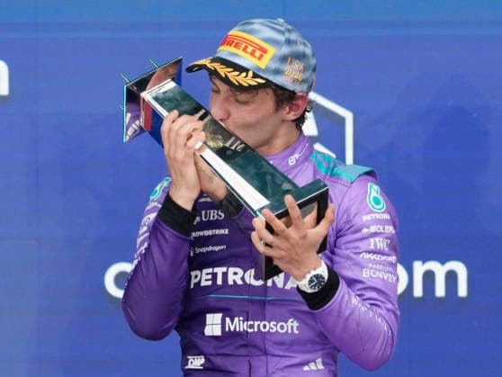 Mercedes-AMG Petronas driver Kimi Antonelli of Italy kisses his trophy after winning the Formula One Miami Grand Prix at the Miami International Autodrome in Miami Gardens, Florida on Sunday, May 3, 2026. McLaren driver Lando Norris of Britain finished in second and McLaren driver Oscar Piastri of Australia finished third.  MIA20260503914 GREGxNASH