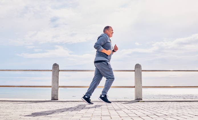 Senior man running outdoor at beach promenade, sky mockup and energy for body, wellness and cardio workout. Elderly male, exercise and runner at seaside for sports training, fitness or healthy action. (License=RF) 19888363 ,model released, Symbolfoto  Copyright: xZoonar.com KasperxRavlox 19888363 ,model released, Symbolfoto ,property released