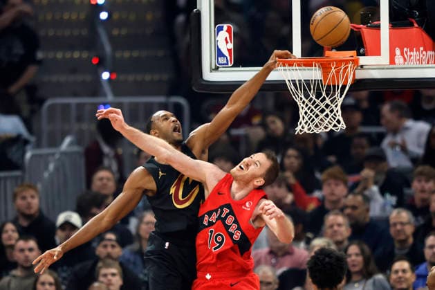 Cleveland Cavalier s Evan Mobley (4) attempts a dunk over Toronto Raptors Jakob Poeltl (19) in the first quarter in Cleveland, Ohio Sunday May 3, 2026. The Cavaliers defeated the Raptors 114-102 to advance to play the Detroit Pistons.  CLE20260503119 AARONxJOSEFCZYK